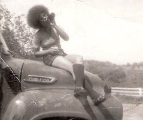 1971 - An unidentified young lady sits atop an old Ford pickup truck somewhere in the mountainous regions of Fauquier County, Virginia